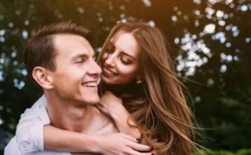 Casal sob um c&eacute;u estrelado com a roda do zod&iacute;aco ao fundo, ilustrando a compatibilidade entre signos no amor